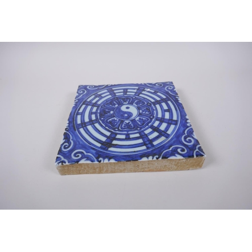 45 - A Chinese blue and white porcelain temple tile with Yin Yang decoration, 19 x 19cm