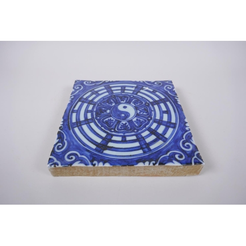 45 - A Chinese blue and white porcelain temple tile with Yin Yang decoration, 19 x 19cm