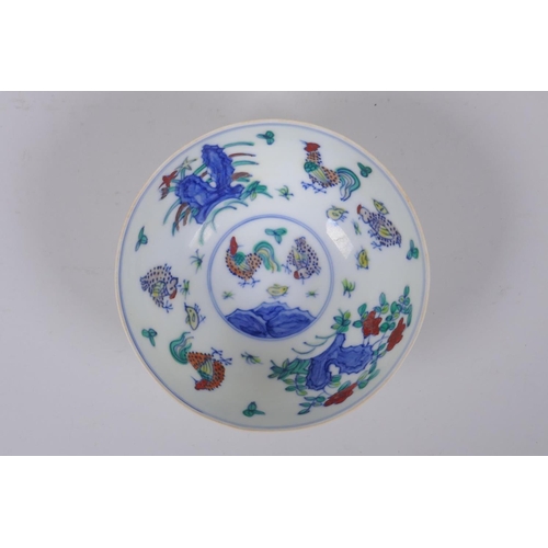 48 - A Doucai porcelain rice bowl with chicken decoration to the interior and incised bird and berry deco... 