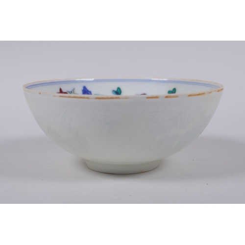 48 - A Doucai porcelain rice bowl with chicken decoration to the interior and incised bird and berry deco... 