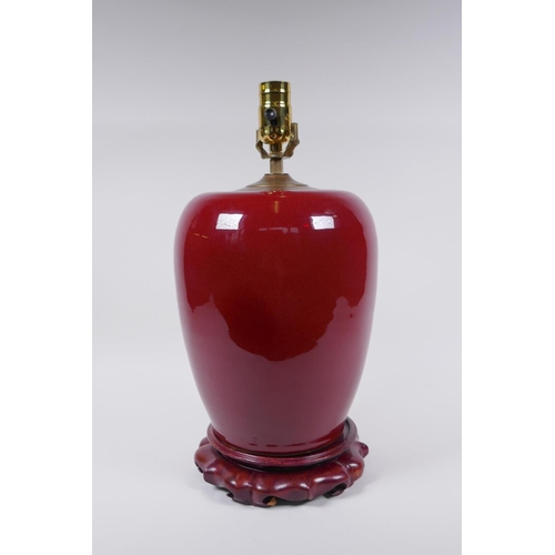 50 - A Chinese flambe glazed ginger jar converted to a lamp with a hardwood stand, 40cm high