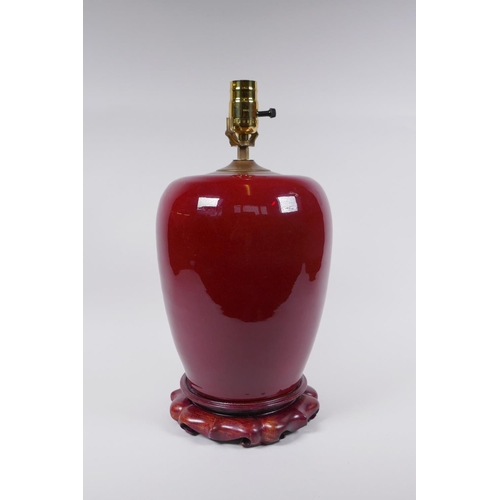 50 - A Chinese flambe glazed ginger jar converted to a lamp with a hardwood stand, 40cm high