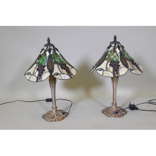 51 - A pair of Tiffany style table lamps, with metal bases and glass shades, 55cm high