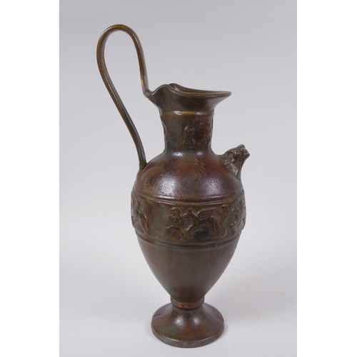 52 - A solid bronze ewer with cast Greco Roman style decoration, 35cm high