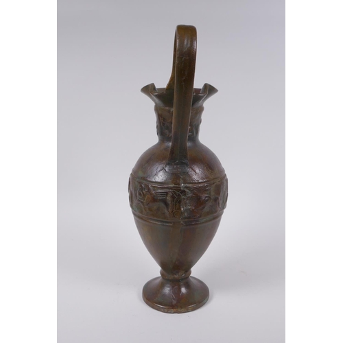 52 - A solid bronze ewer with cast Greco Roman style decoration, 35cm high