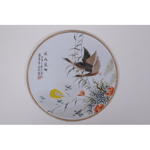 55 - A Chinese Republic style porcelain panel decorated with waterfowl and flora, 27cm diameter