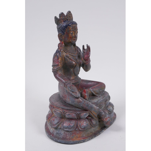 56 - A Sino Tibetan bronze figure of a female deity seated on a lotus throne, with the remnants of gilt a... 