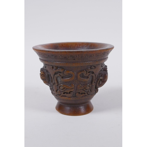 60 - A Chinese faux horn libation cup with raised kylin decoration, seal mark to base, 8cm high x 10cm di... 