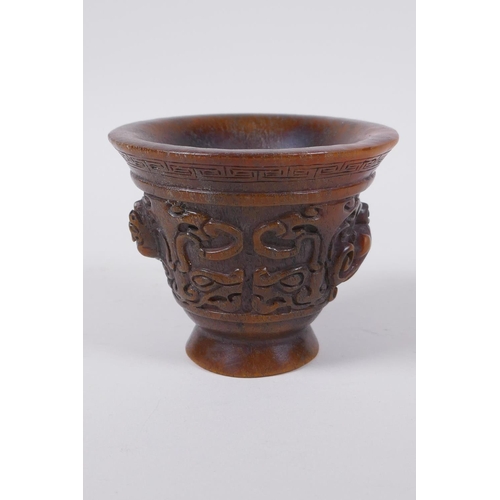 60 - A Chinese faux horn libation cup with raised kylin decoration, seal mark to base, 8cm high x 10cm di... 