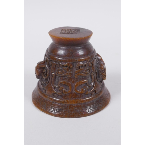 60 - A Chinese faux horn libation cup with raised kylin decoration, seal mark to base, 8cm high x 10cm di... 