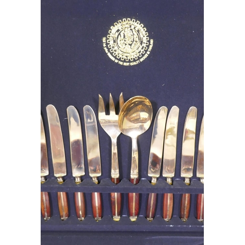 64 - A Thai bronze and rosewood twelve place cutlery set in wood canteen, appears unused