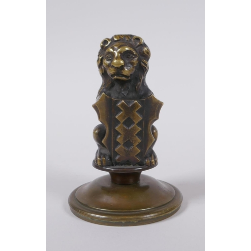 67 - A bronze heraldic mount in the form of a lion with a shield, 10cm high