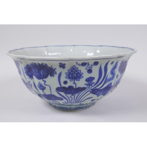 70 - A blue and white porcelain bowl of lobed form decorated with carp in a lotus pond, Chinese Xuande 6 ... 