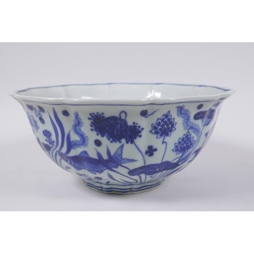 70 - A blue and white porcelain bowl of lobed form decorated with carp in a lotus pond, Chinese Xuande 6 ... 