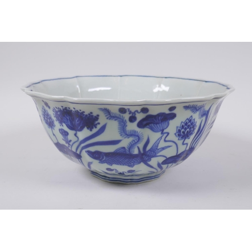 70 - A blue and white porcelain bowl of lobed form decorated with carp in a lotus pond, Chinese Xuande 6 ... 