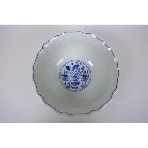 70 - A blue and white porcelain bowl of lobed form decorated with carp in a lotus pond, Chinese Xuande 6 ... 