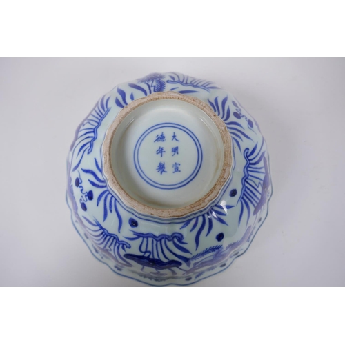 70 - A blue and white porcelain bowl of lobed form decorated with carp in a lotus pond, Chinese Xuande 6 ... 