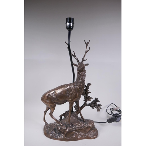 74 - A bronzed composition lamp in the form of a stag, 62cm high without shade