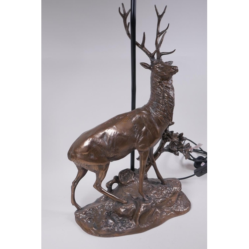 74 - A bronzed composition lamp in the form of a stag, 62cm high without shade