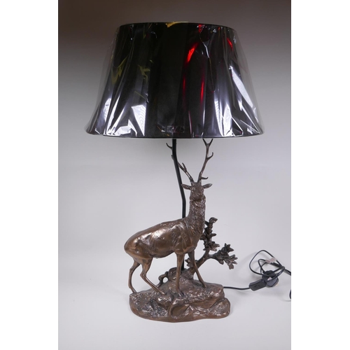 74 - A bronzed composition lamp in the form of a stag, 62cm high without shade