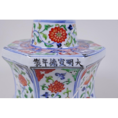 78 - A Chinese wucai porcelain candlestick of octagonal form with decorative floral panels, 28cm high, AF