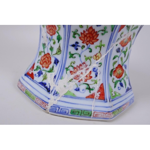 78 - A Chinese wucai porcelain candlestick of octagonal form with decorative floral panels, 28cm high, AF