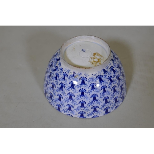 84 - An C18th/C19th pearlware bowl with blue and white transfer decoration of harebells, repairs to foot,... 