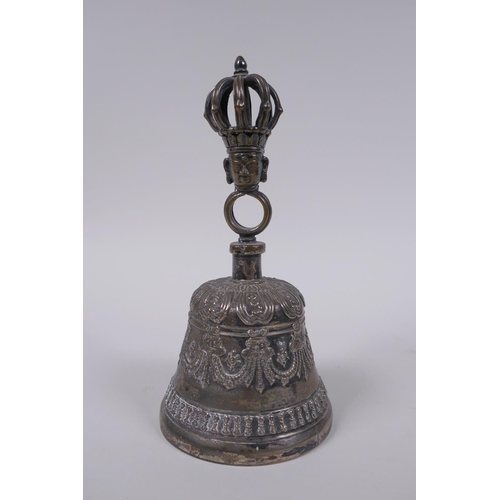 86 - A Sino Tibetan silvered metal ceremonial bell with vajra decoration to handle, 18cm high