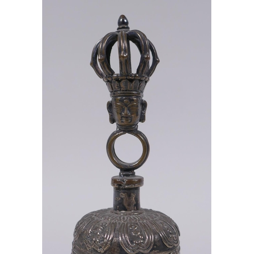 86 - A Sino Tibetan silvered metal ceremonial bell with vajra decoration to handle, 18cm high