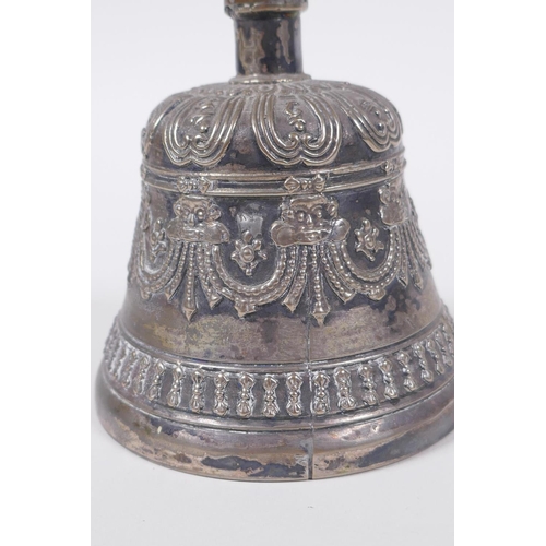 86 - A Sino Tibetan silvered metal ceremonial bell with vajra decoration to handle, 18cm high