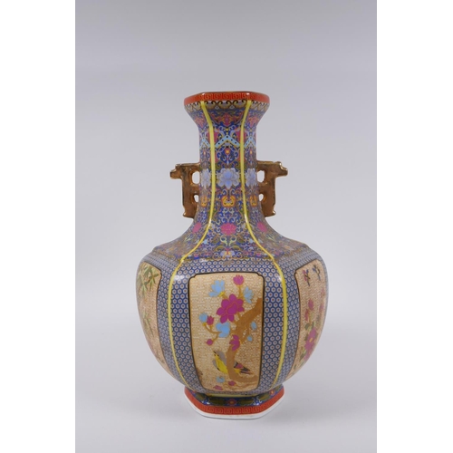 90 - A Chinese polychrome porcelain two handled vase with decorative panels depicting birds, butterflies ... 