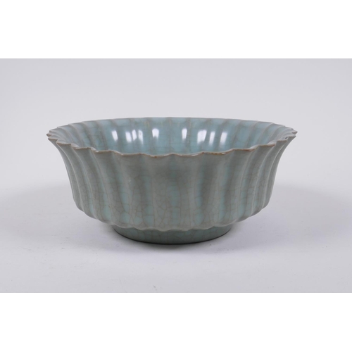 98 - A Chinese celadon crackle glazed porcelain bowl of ribbed form, with flared rim, AF chip to rim, 17c... 