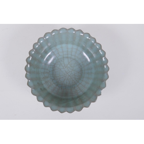 98 - A Chinese celadon crackle glazed porcelain bowl of ribbed form, with flared rim, AF chip to rim, 17c... 