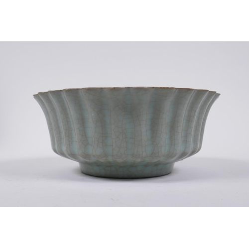 98 - A Chinese celadon crackle glazed porcelain bowl of ribbed form, with flared rim, AF chip to rim, 17c... 