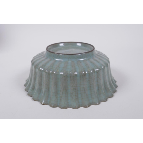 98 - A Chinese celadon crackle glazed porcelain bowl of ribbed form, with flared rim, AF chip to rim, 17c... 