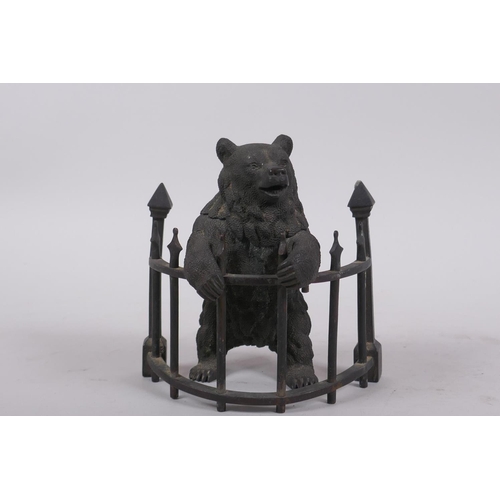 1 - A C19th finely cast patinated bronze inkwell in the form of a bear behind railings, 12cm high