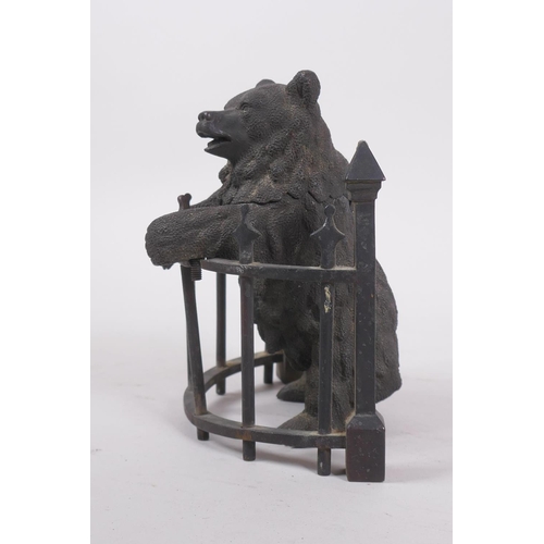 1 - A C19th finely cast patinated bronze inkwell in the form of a bear behind railings, 12cm high