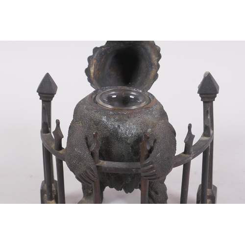 1 - A C19th finely cast patinated bronze inkwell in the form of a bear behind railings, 12cm high