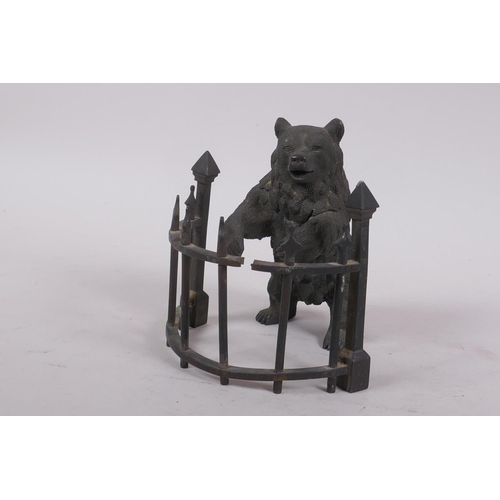 1 - A C19th finely cast patinated bronze inkwell in the form of a bear behind railings, 12cm high