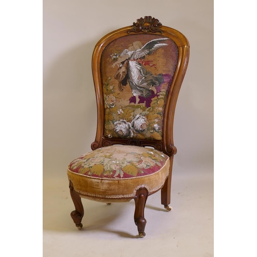 1017 - A Victorian walnut nursing chair with carved crest and shaped back, beadwork upholstery, raised on c... 