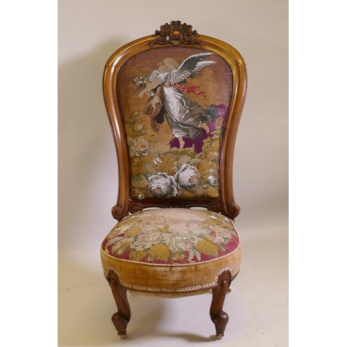 1017 - A Victorian walnut nursing chair with carved crest and shaped back, beadwork upholstery, raised on c... 