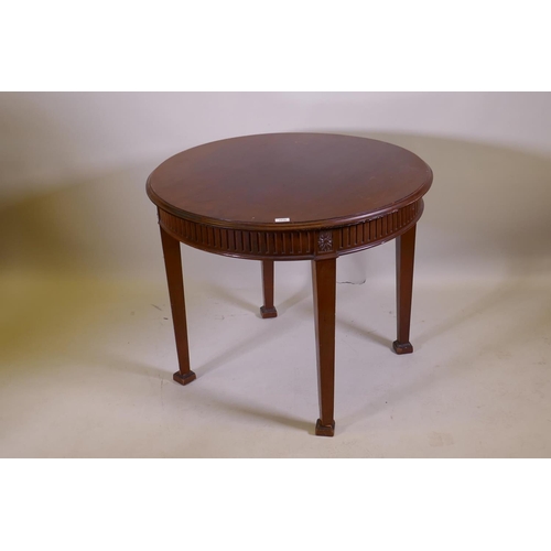 1018 - An Adam style mahogany centre table, with fluted frieze and patarae  decoration, raised on square ta... 