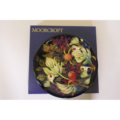 102 - A Moorcroft pottery charger in the Queen's Choice pattern, designed by Emma Bossons, signed BM, in o... 