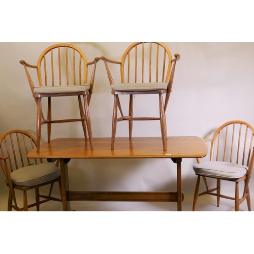 1022 - An Ercol 1960s elm Old Colonial refectory table, four Ercol elm and beech hoop back Windsor armchair... 