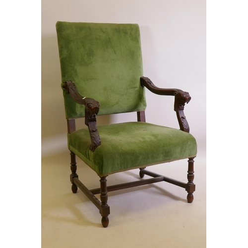 1029 - A C19th high back open arm chair with carved lion mask arms, raised on turned supports, AF