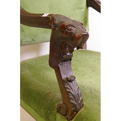 1029 - A C19th high back open arm chair with carved lion mask arms, raised on turned supports, AF