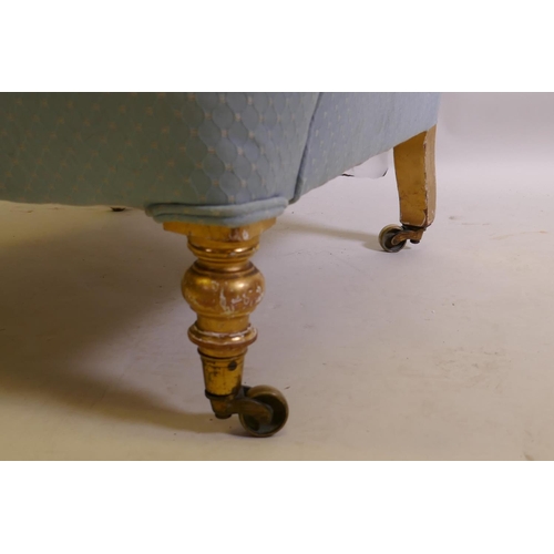 1030 - A C19th humpback nursing chair, on turned water gilt supports and brass castors