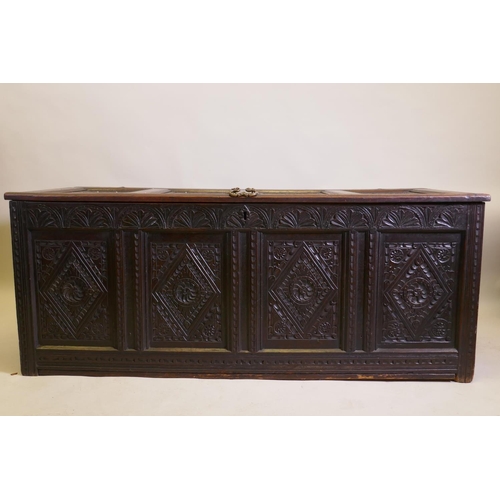 1031 - An C18th continental carved oak four panel coffer, 157 x 65cm, 63cm high