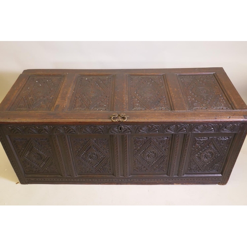 1031 - An C18th continental carved oak four panel coffer, 157 x 65cm, 63cm high