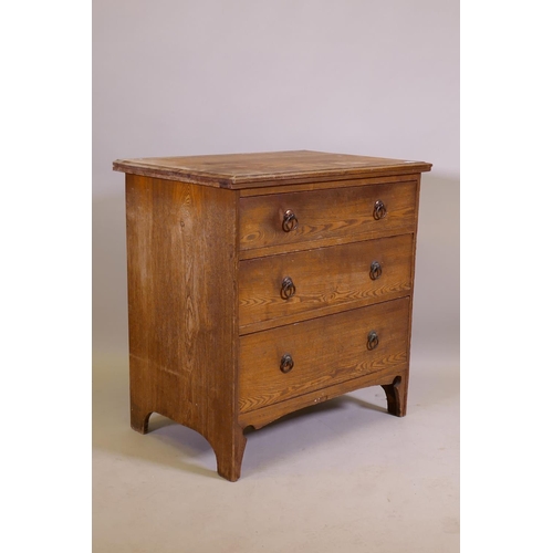 1034 - An Arts & Crafts oak three drawer chest, raised on shaped supports, 74 x 49 x 77cm